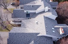 Aerial view of a roof replacement project captured by drone, showcasing the precision and progress.